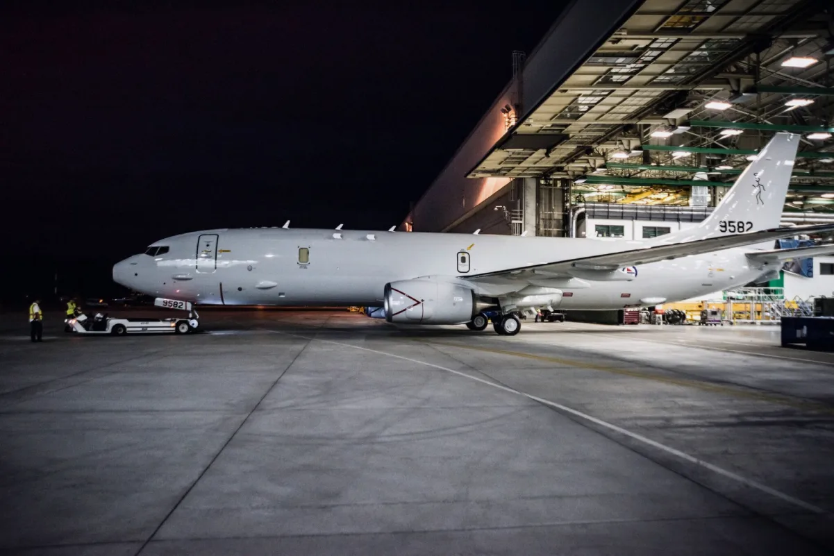 Aircraft outside a maintenance hangar at night