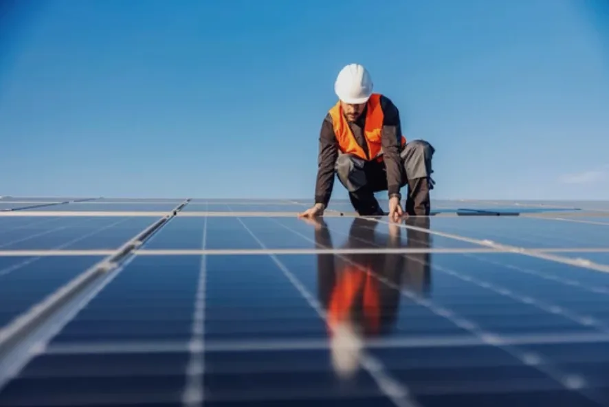 Technician inspecting a solar panel installation